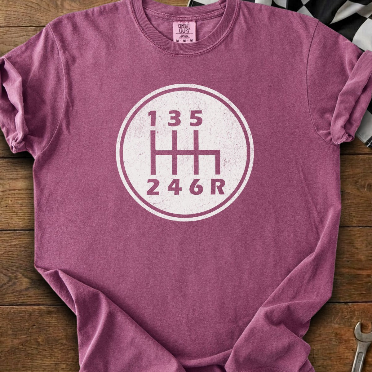Maroon t-shirt with white 6-speed manual transmission shift pattern graphic.