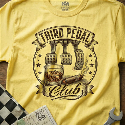 Yellow t-shirt with "Third Pedal Club" text, clutch pedals, whiskey, and cigar graphic.