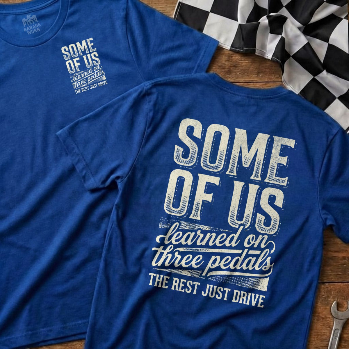 Blue t-shirts with "SOME OF US learned on three pedals THE REST JUST DRIVE" text.