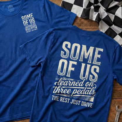 Blue t-shirts with "SOME OF US learned on three pedals THE REST JUST DRIVE" text.