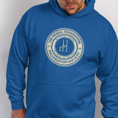 Blue hoodie with "Manual Transmission Preservation Society" logo and gear shift.