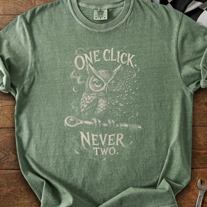 Green t-shirt with an owl graphic and text "ONE CLICK NEVER TWO".