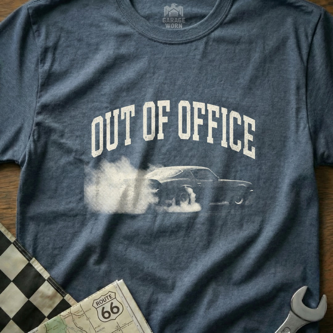Dark blue t-shirt with "OUT OF OFFICE" graphic featuring a car doing a burnout.