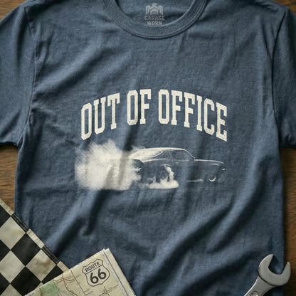 Dark blue t-shirt with "OUT OF OFFICE" graphic featuring a car doing a burnout.