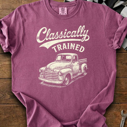 Berry colored t-shirt with white text "Classically TRAINED" and a drawing of a vintage truck.