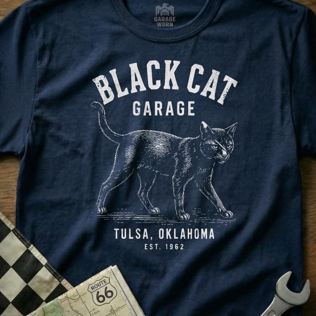 Navy t-shirt with "Black Cat Garage Tulsa, Oklahoma Est. 1962" and cat graphic.