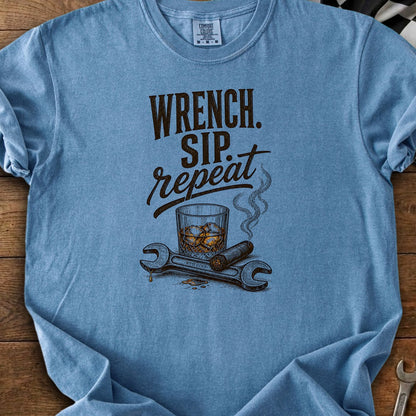 Blue t-shirt with "Wrench. Sip. Repeat." text, whiskey, cigar, and wrenches.