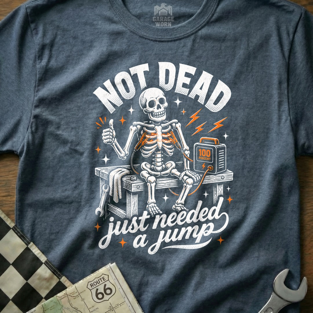 Skeleton giving thumbs up with jumper cables attached, "NOT DEAD just needed a jump".