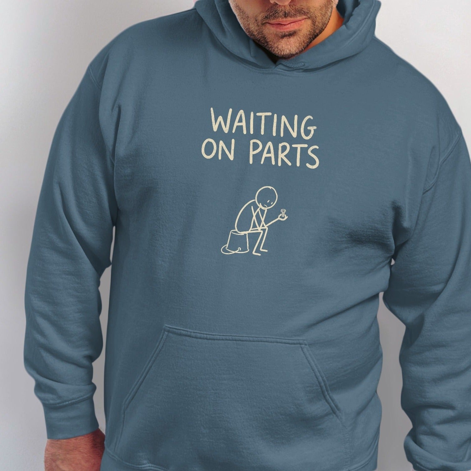 Teal hoodie with "WAITING ON PARTS" text and a stick figure.