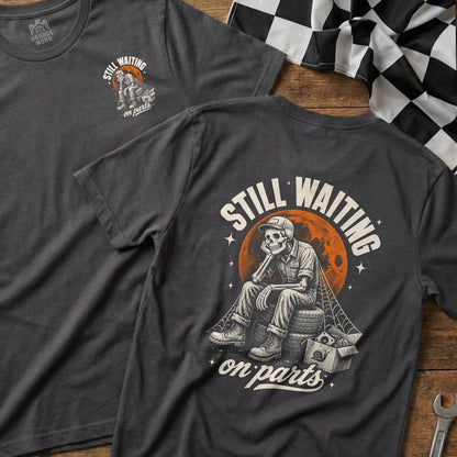 Skeleton sitting on tires with "STILL WAITING on parts" text and checkered flag.