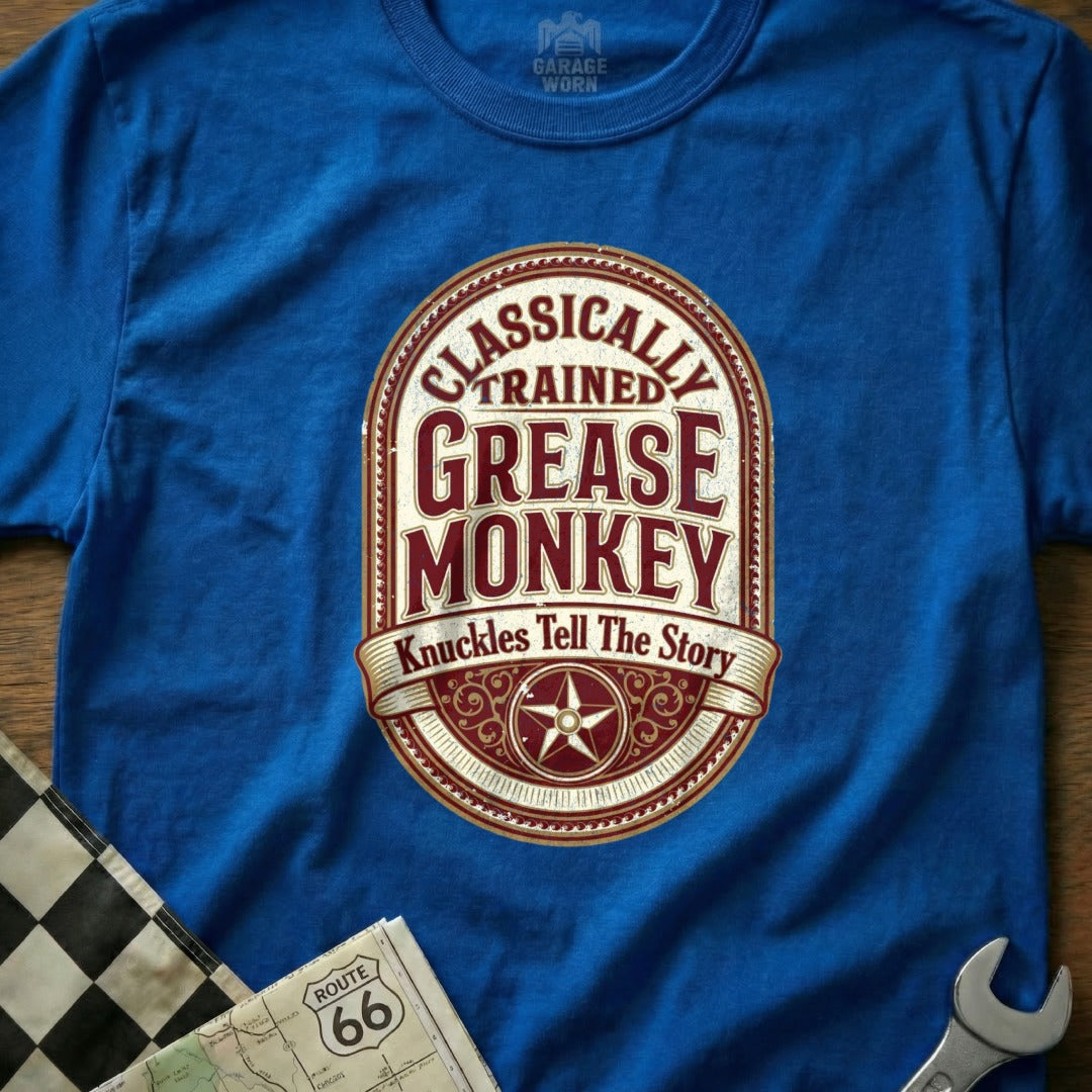 Blue t-shirt with "Classically Trained Grease Monkey Knuckles Tell The Story" oval graphic.