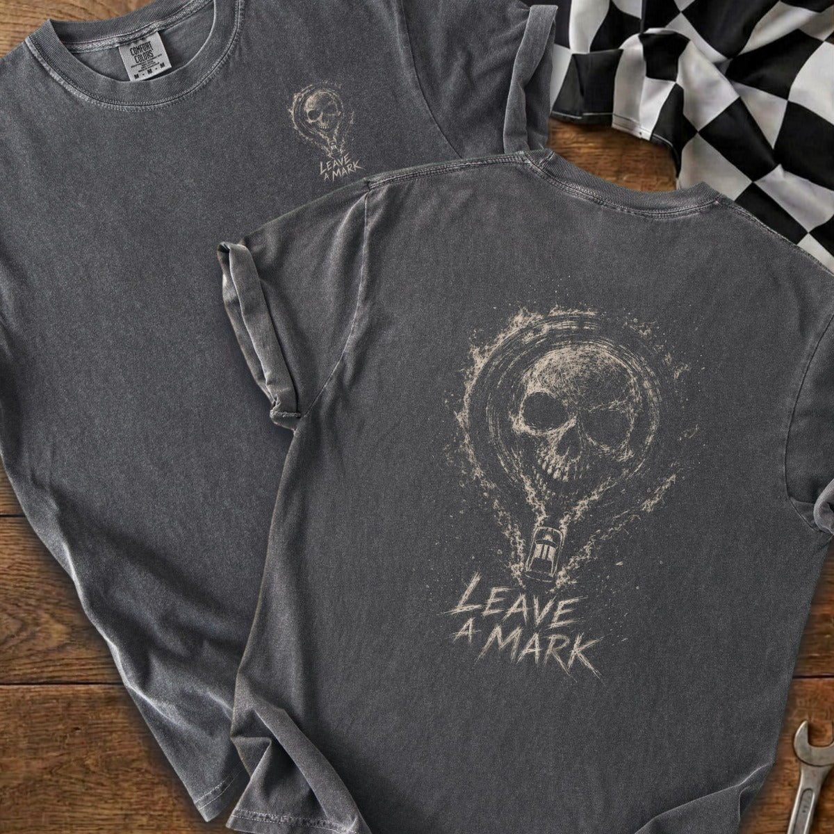 Dark grey t-shirt with skull graphic and "LEAVE A MARK" text on the back.