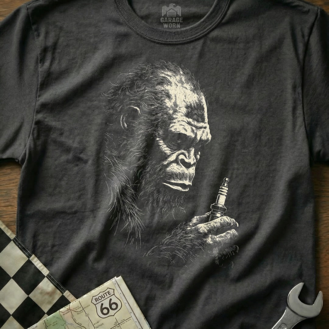 T-shirt with Bigfoot holding a spark plug, Route 66 map, and wrench.