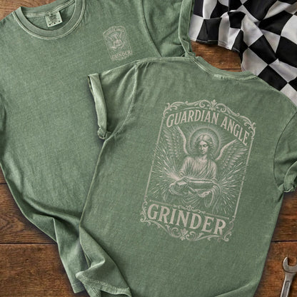 Green t-shirt with guardian angel graphic and text "GRINDER" on the back.