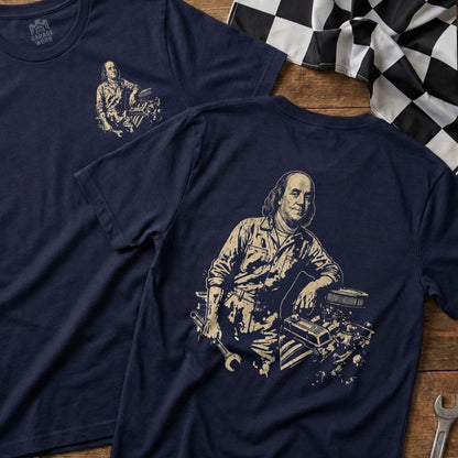 Navy t-shirt featuring Benjamin Franklin leaning on an engine block.