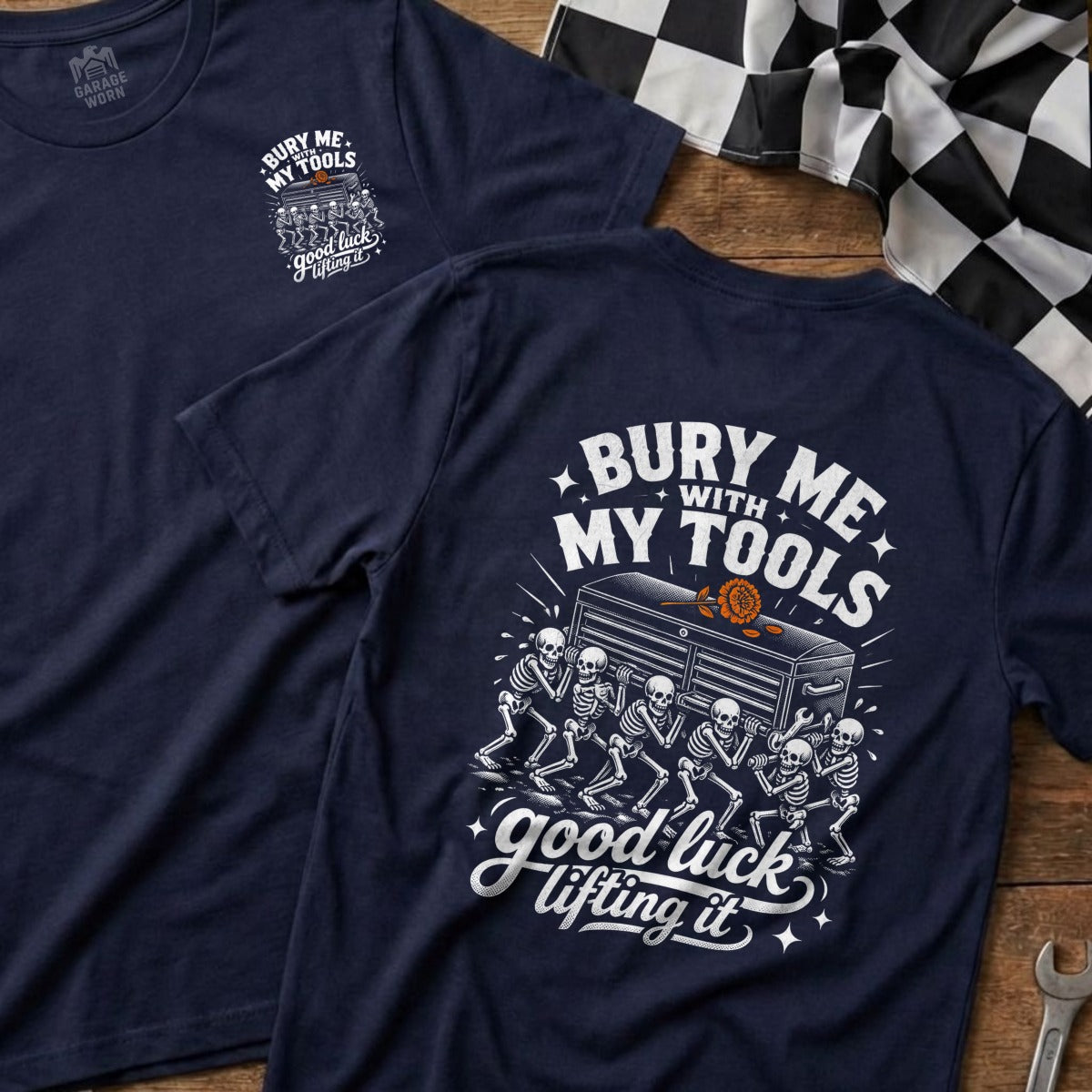 Navy t-shirt with graphic of skeletons carrying a toolbox and text "Bury Me With My Tools Good Luck Lifting It".