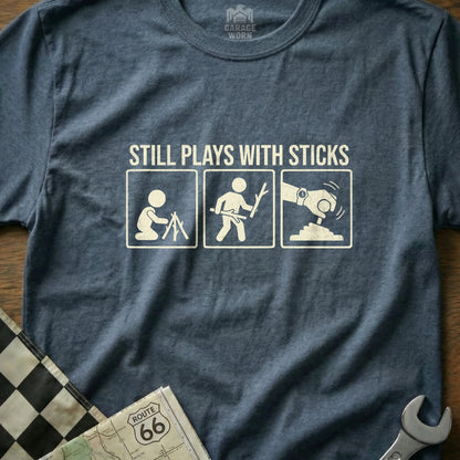 T-shirt with three stick figures: one setting up a tent, one with a stick, one with a robotic arm.
