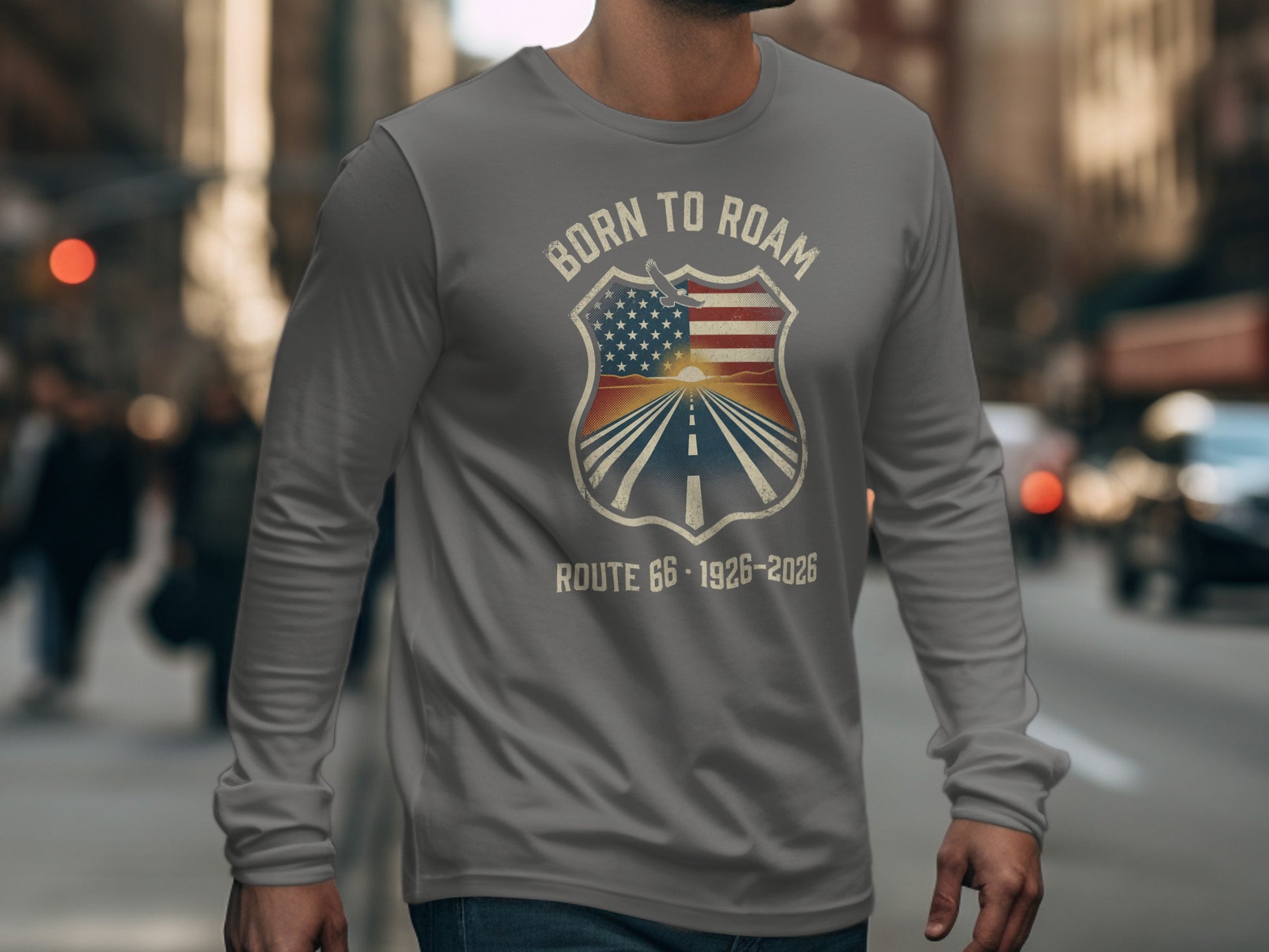 Gray long-sleeve t-shirt with "Born to Roam" shield graphic featuring US flag and road.
