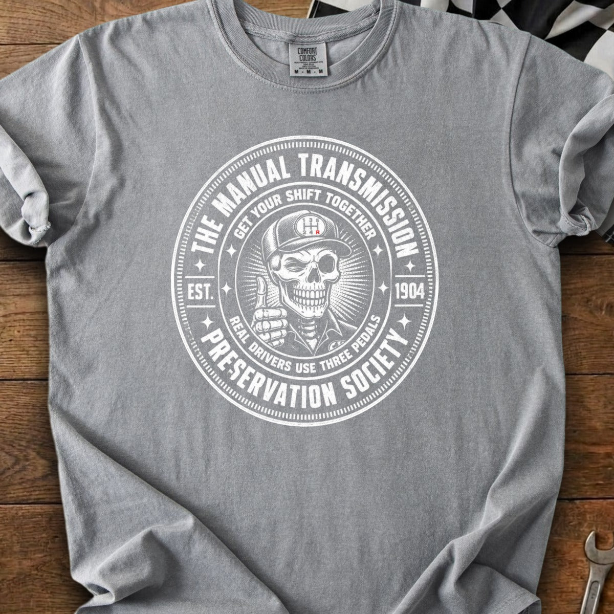 Grey t-shirt with circular graphic: "The Manual Transmission Preservation Society" with a skeleton.
