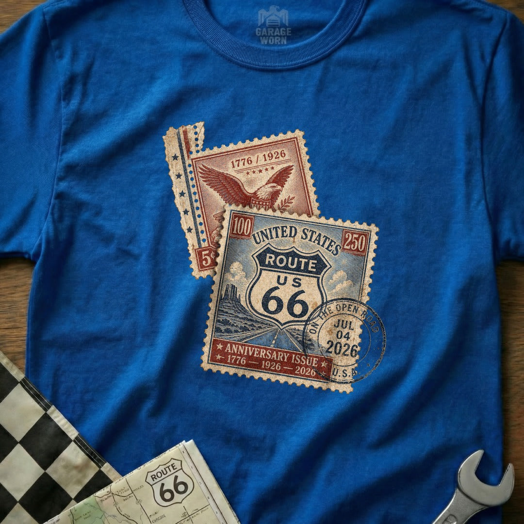 Blue t-shirt with Route 66 anniversary stamps and a checkered flag.