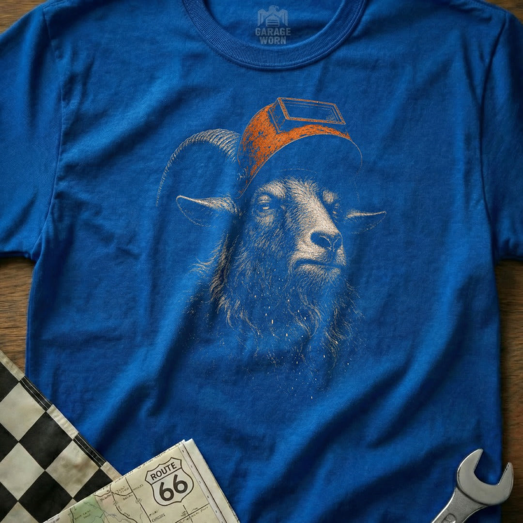 Blue t-shirt with a distressed graphic of a goat wearing a welding mask, "GARAGE WORN" logo above.