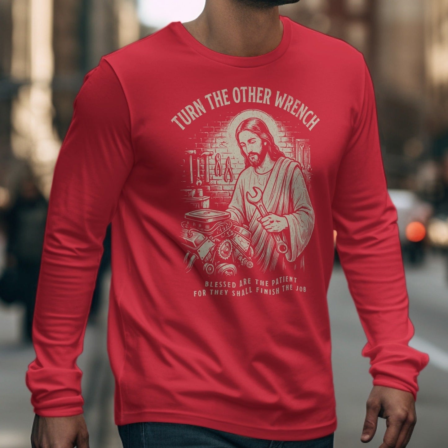 Red long-sleeve shirt with Jesus holding a wrench and text saying "Turn the other wrench".