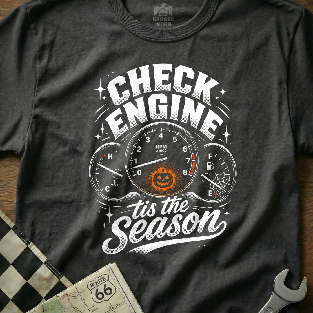 "Check Engine tis the Season" graphic with a jack-o'-lantern on a dark t-shirt.