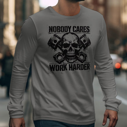 Grey long-sleeve shirt with skull, pistons, and text: Nobody Cares Work Harder.
