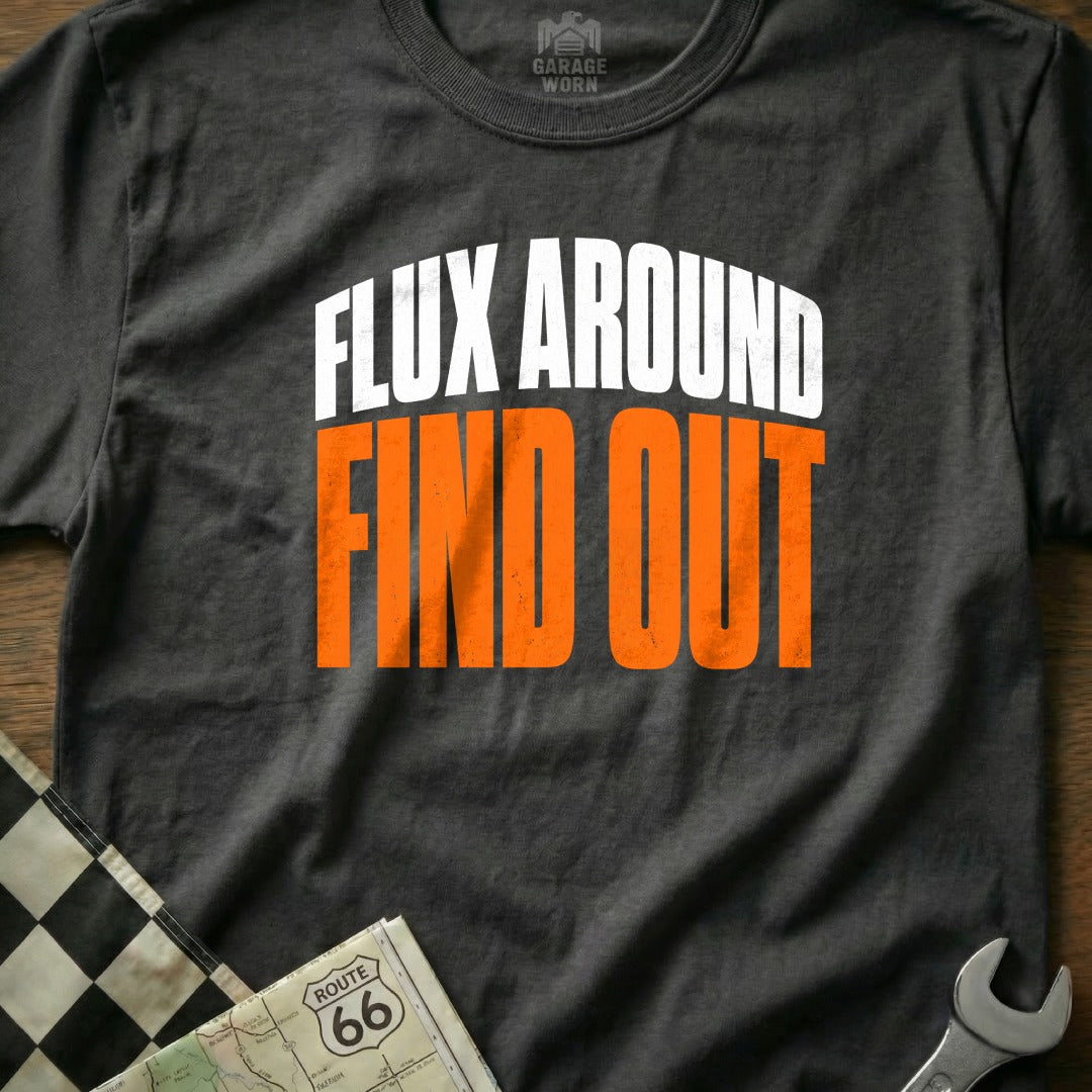 Dark grey t-shirt with white text "FLUX AROUND" above orange text "FIND OUT".