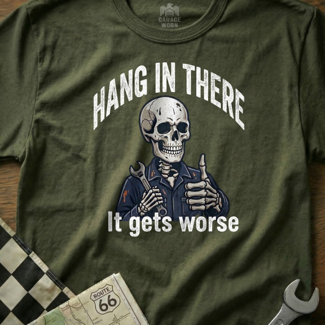 Olive green t-shirt with a skeleton giving a thumbs up and holding a wrench.