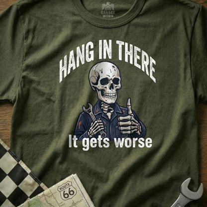 Olive green t-shirt with a skeleton giving a thumbs up and holding a wrench.