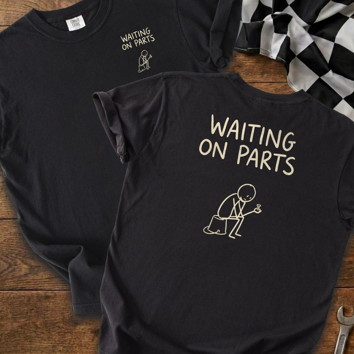 Black t-shirt with "WAITING ON PARTS" text and stick figure holding a bolt.