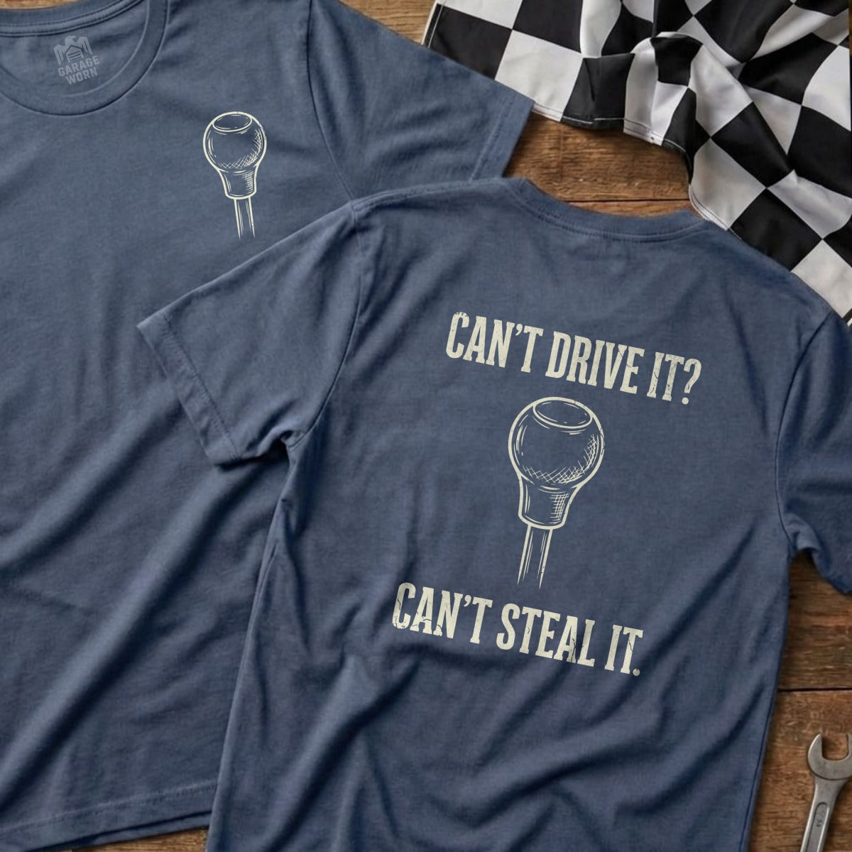 Blue t-shirt with gear shift graphic and text: Can't Drive It? Can't Steal It.