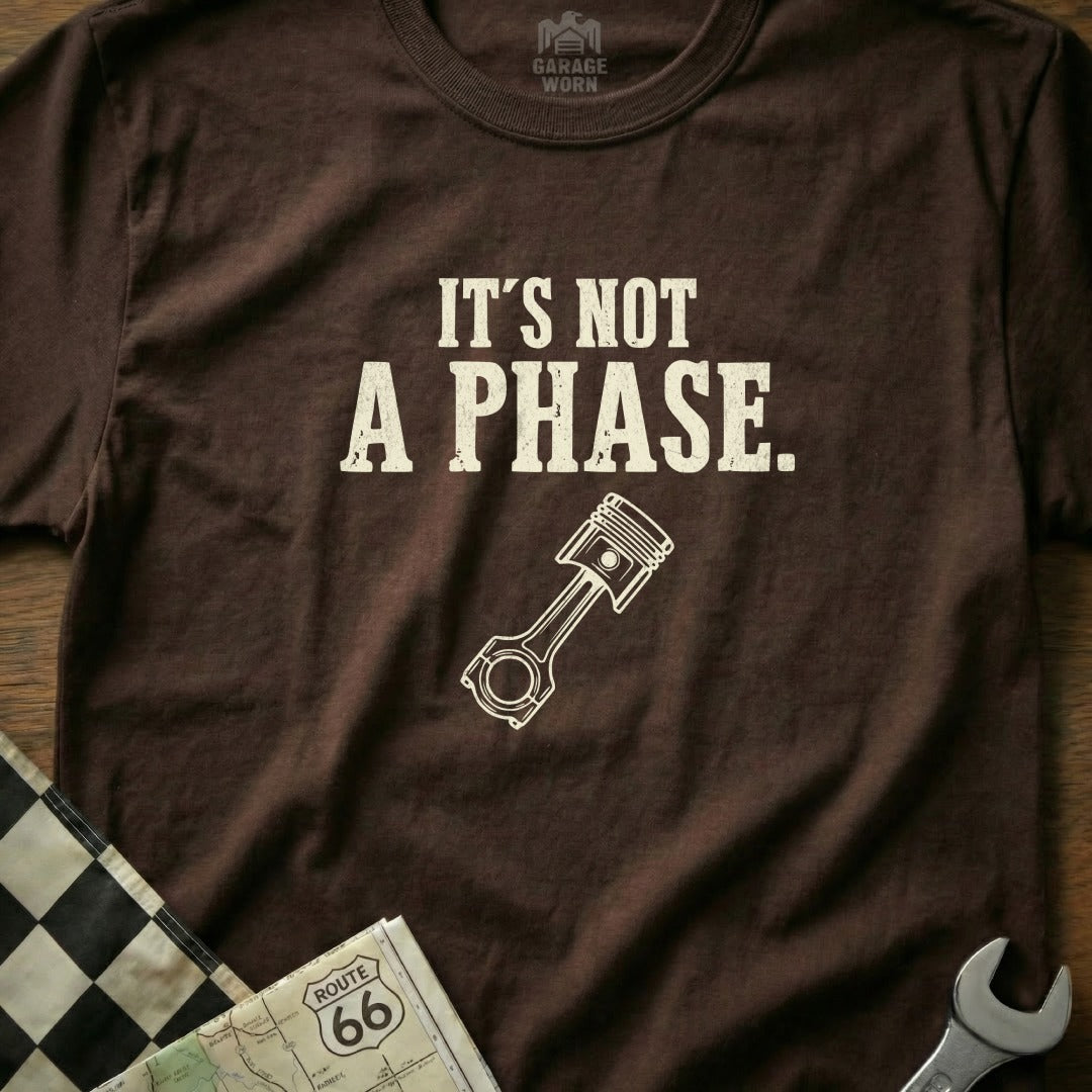Brown t-shirt with "It's NOT A PHASE." text and a piston graphic.