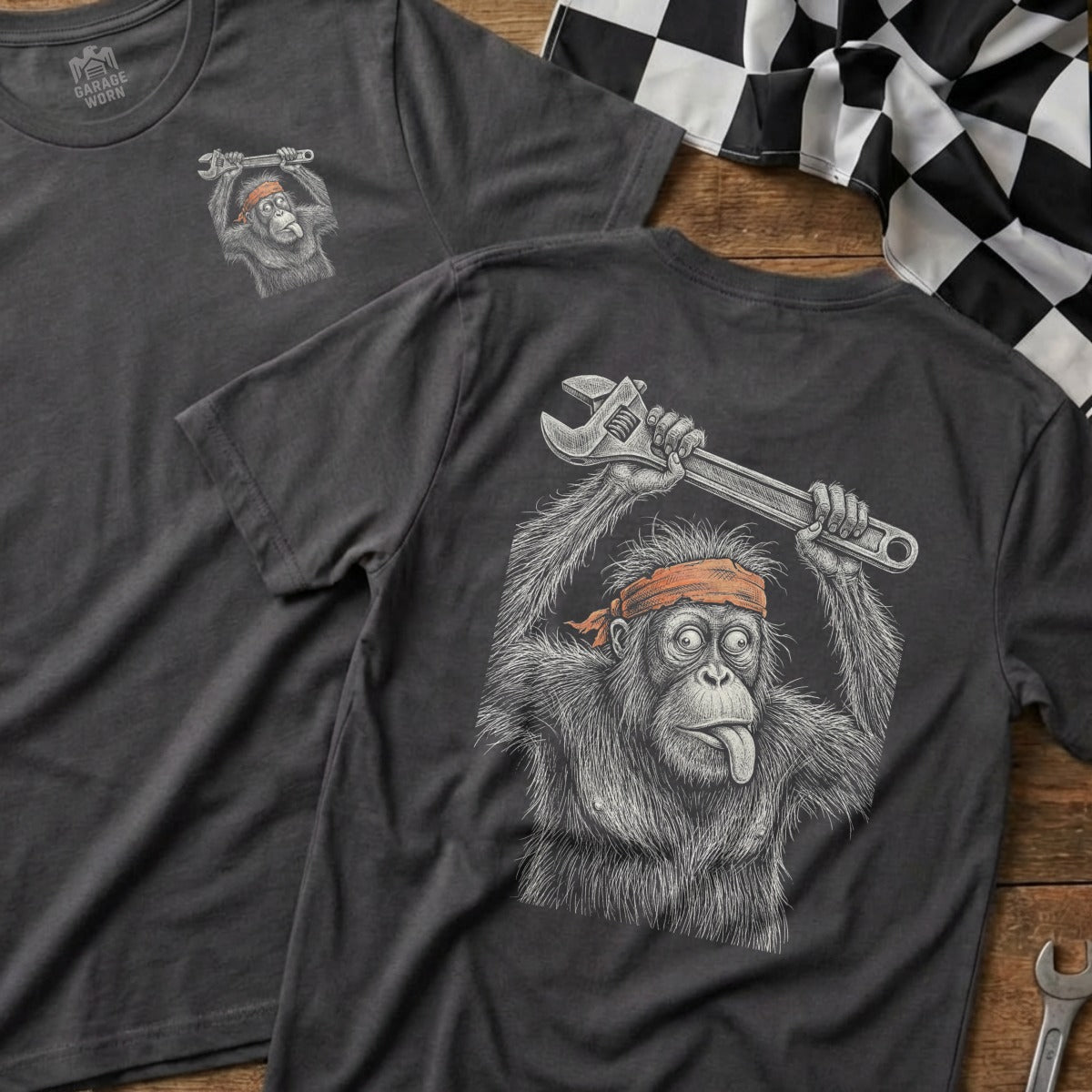 Dark gray t-shirt with illustration of an orangutan holding a wrench, tongue out.