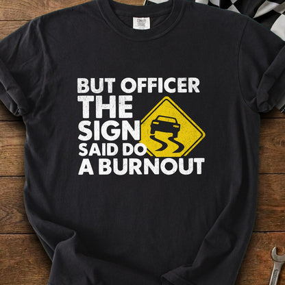 Black t-shirt with white text: "BUT OFFICER THE SIGN SAID DO A BURNOUT"