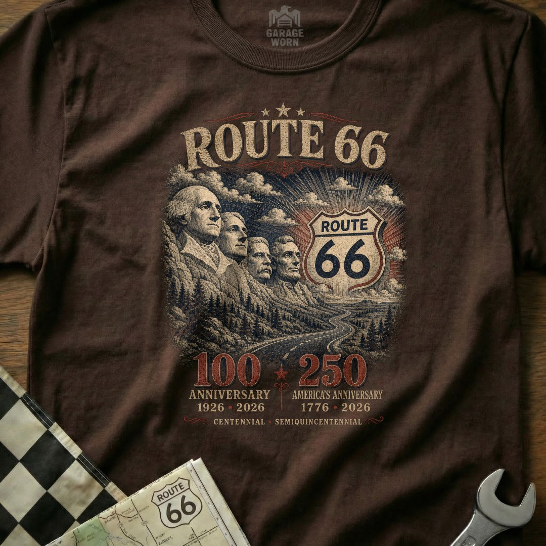 Brown t-shirt graphic with Mount Rushmore, Route 66 shield, and anniversary text.