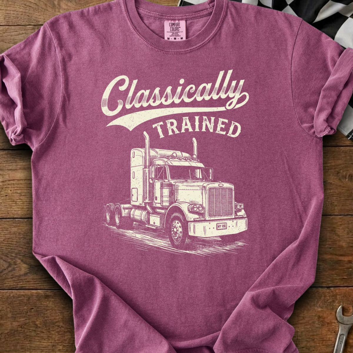 Burgundy t-shirt with white distressed graphic of a semi-truck and text "Classically TRAINED".