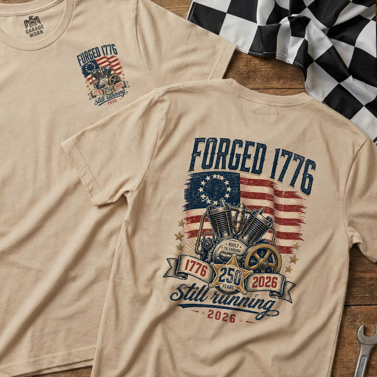 Tan t-shirt with "Forged 1776" graphic featuring a motorcycle engine and American flag.