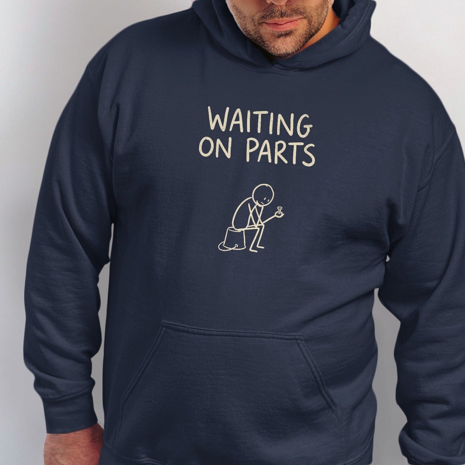 Navy hoodie with "Waiting on Parts" text and stick figure drawing.