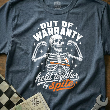 Skeleton wearing a shirt that reads "Out of Warranty, Held Together by Spite".
