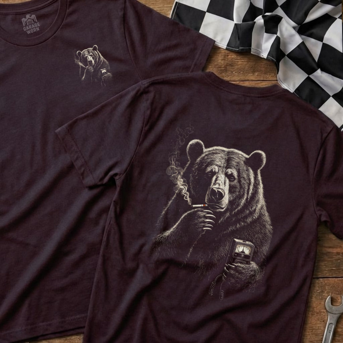 Dark t-shirt with illustration of a bear smoking and holding a device.