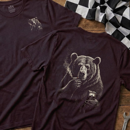Dark t-shirt with illustration of a bear smoking and holding a device.