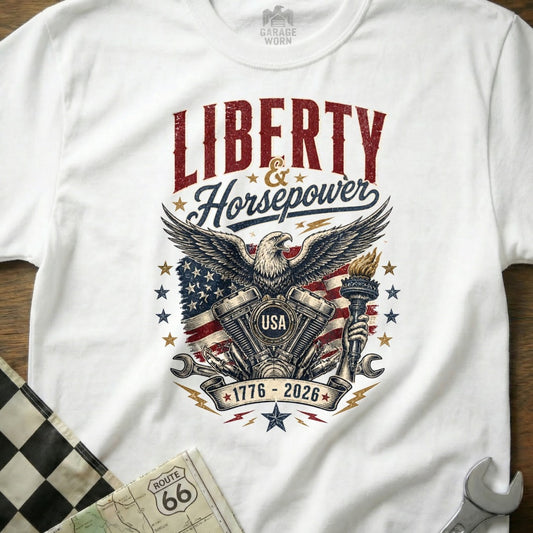 White t-shirt featuring eagle, V-twin engine, US flag, torch, and text "Liberty & Horsepower".