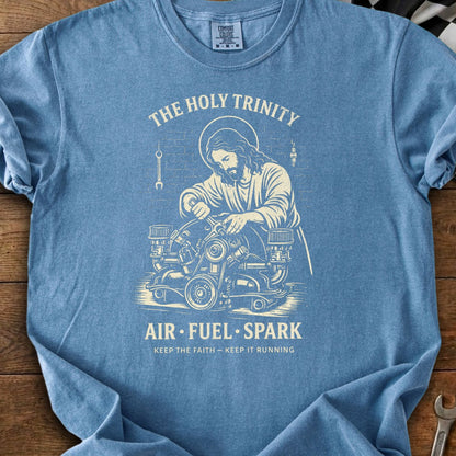 Jesus working on a car engine with text "The Holy Trinity Air Fuel Spark".