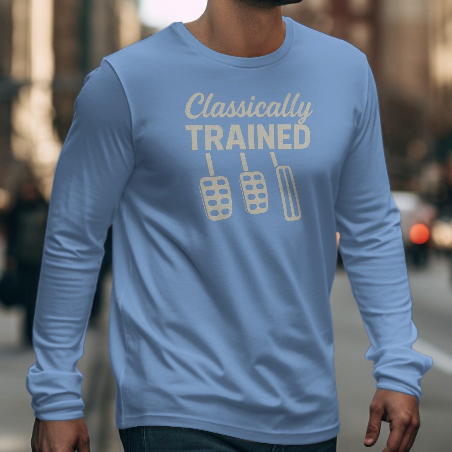 Blue long-sleeve shirt with text "Classically TRAINED" and three clutch pedals.