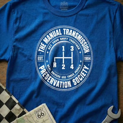 Blue t-shirt with circular graphic for "The Manual Transmission Preservation Society."