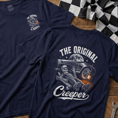 Navy t-shirt with a skeleton mechanic on a creeper under a classic car.