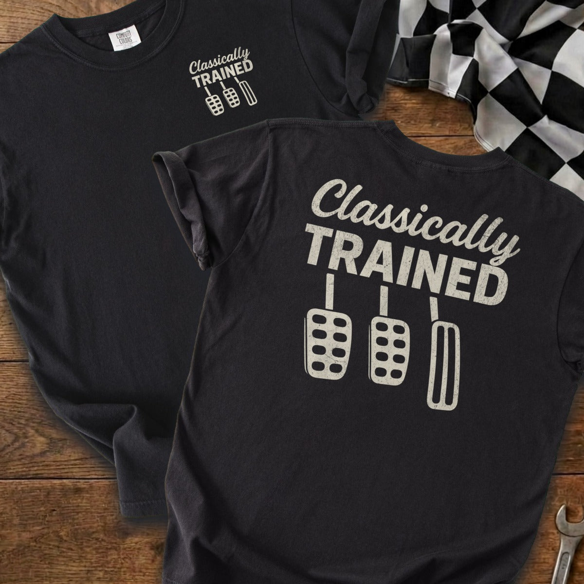 Black t-shirt with "Classically TRAINED" and three car pedals graphic.