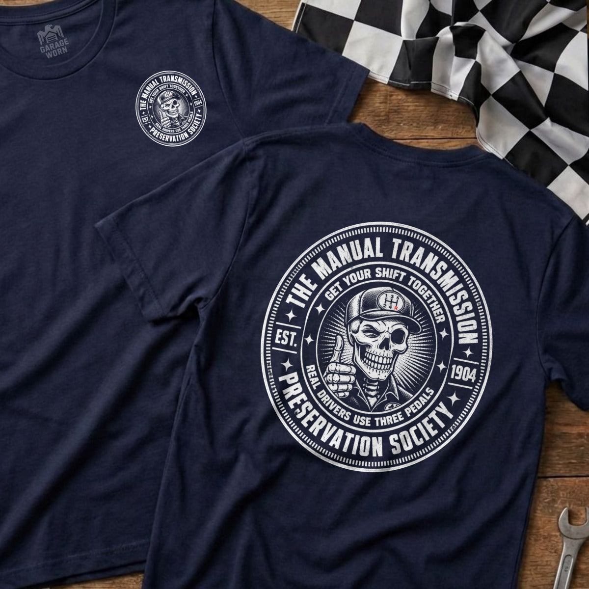 Navy t-shirt with "The Manual Transmission Preservation Society" graphic on back.